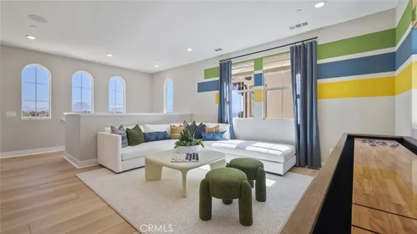 a living room with furniture and wooden floor