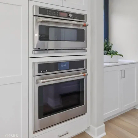 a stove top oven sitting inside of a kitchen