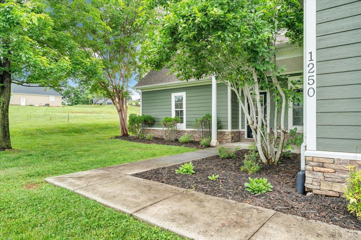 1250 Our Cove Road Huddleston, VA 24104 - Photo 4 of 70 a view of a house with a yard and a garden