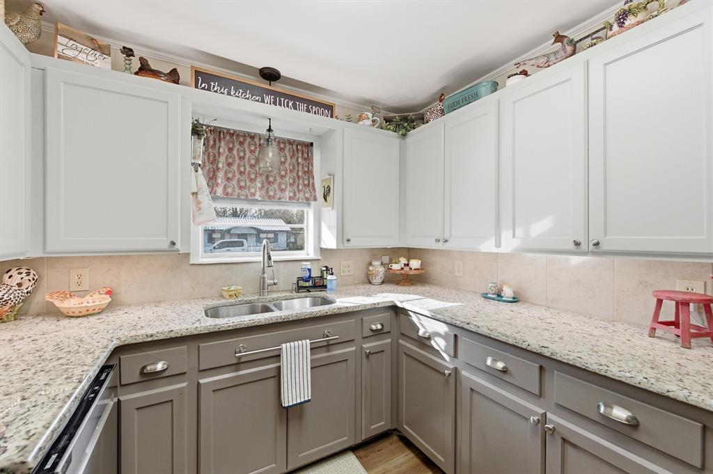 515 Pecan Street Collinsville, TX 76233 - Photo 13 of 39 a kitchen with a sink cabinets and window