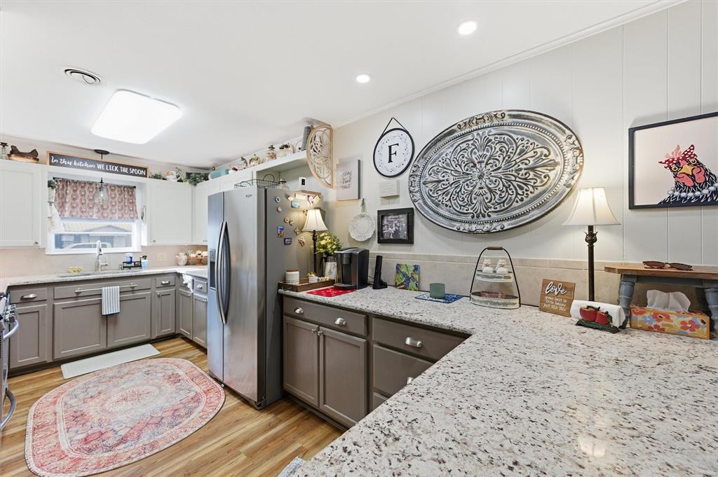 515 Pecan Street Collinsville, TX 76233 - Photo 15 of 39 a kitchen with stainless steel appliances granite countertop a sink stove and refrigerator