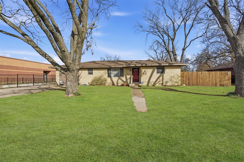 515 Pecan Street Collinsville, TX 76233 - Photo 2 of 39 a front view of a house with garden