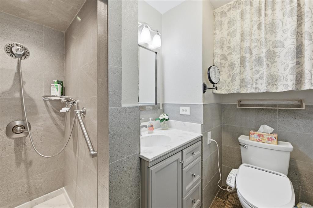 515 Pecan Street Collinsville, TX 76233 - Photo 23 of 39 a bathroom with a sink a toilet and a mirror