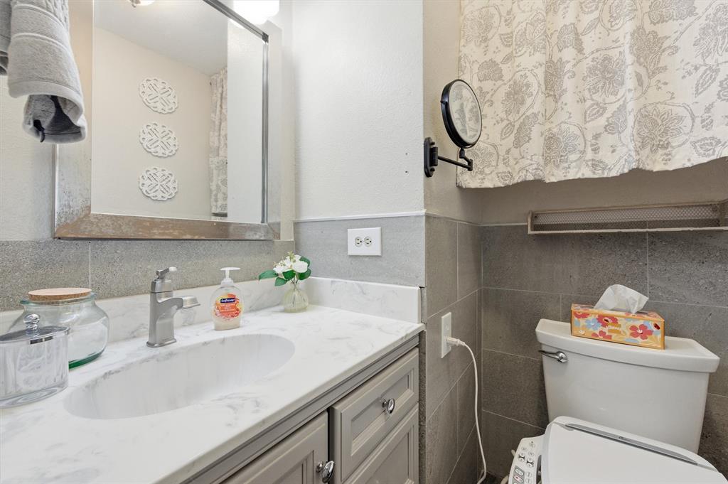 515 Pecan Street Collinsville, TX 76233 - Photo 25 of 39 a bathroom with a sink and a toilet