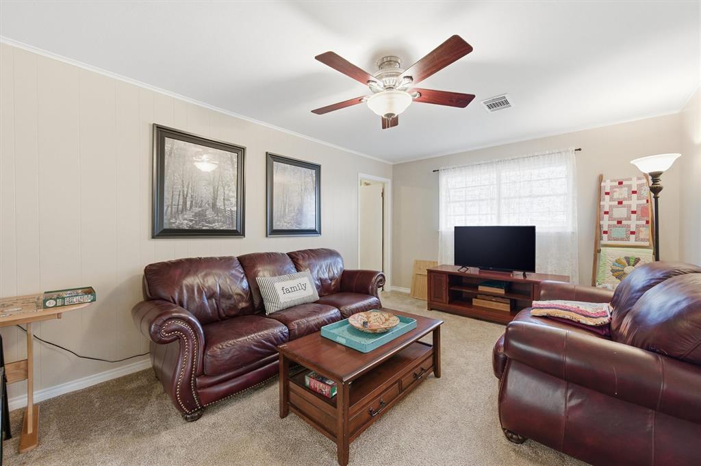 515 Pecan Street Collinsville, TX 76233 - Photo 26 of 39 a living room with furniture and a flat screen tv