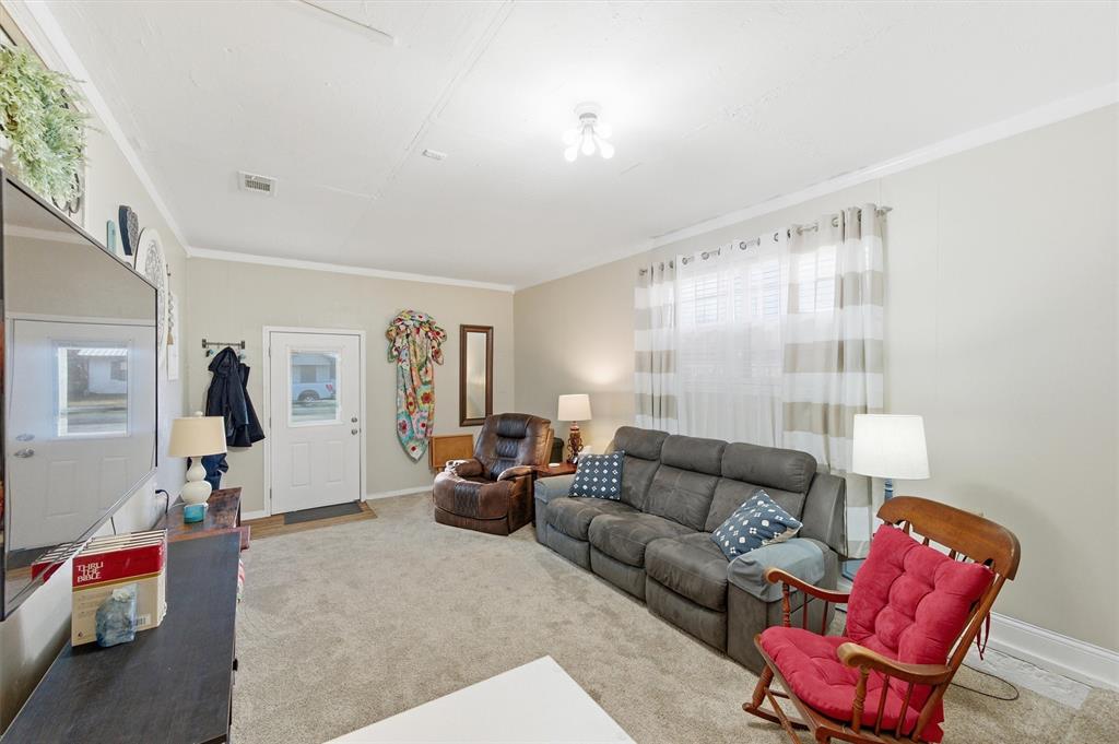 515 Pecan Street Collinsville, TX 76233 - Photo 30 of 39 a living room with furniture and a couch