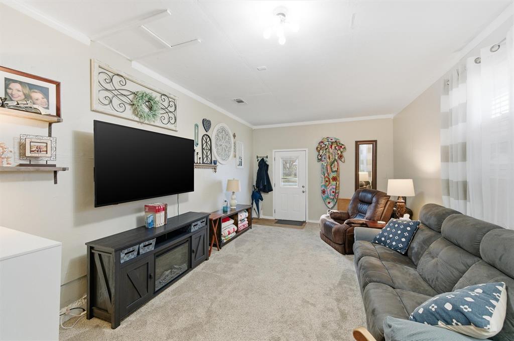 515 Pecan Street Collinsville, TX 76233 - Photo 31 of 39 a living room with furniture and a flat screen tv