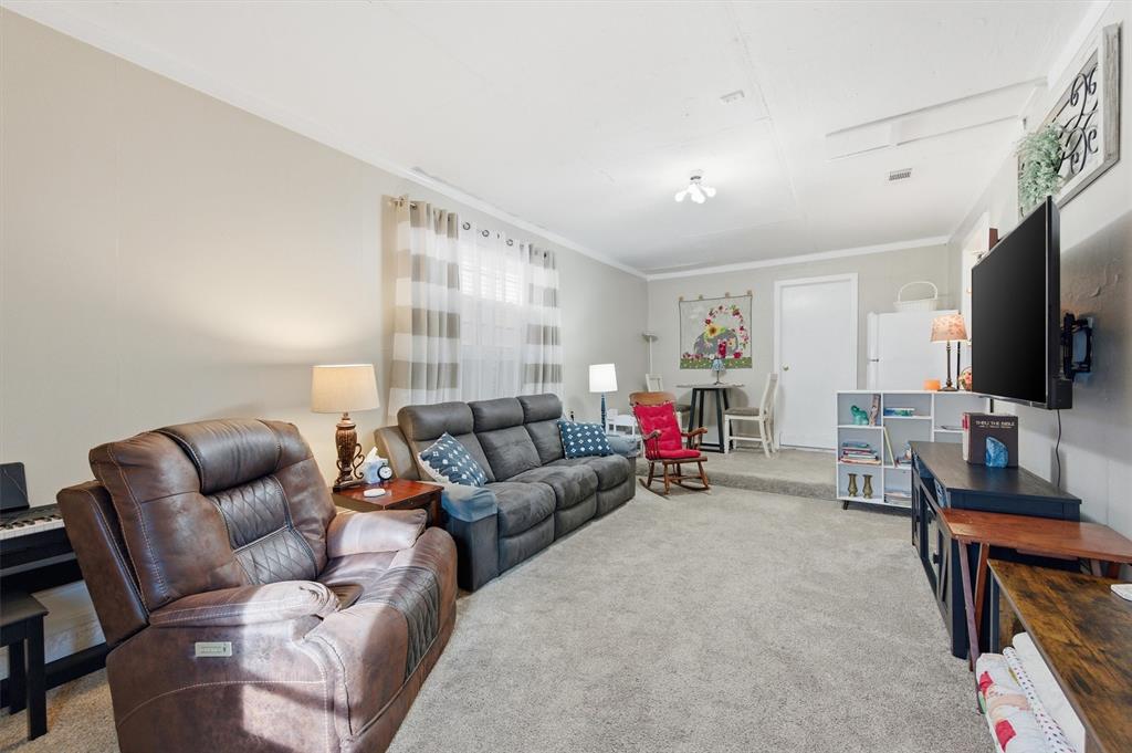 515 Pecan Street Collinsville, TX 76233 - Photo 32 of 39 a living room with furniture and a flat screen tv