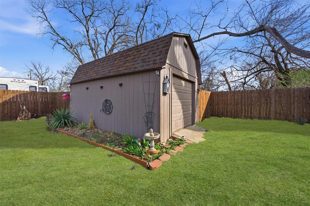 515 Pecan Street Collinsville, TX 76233 - Photo 38 of 39 a backyard of a house with lots of green space
