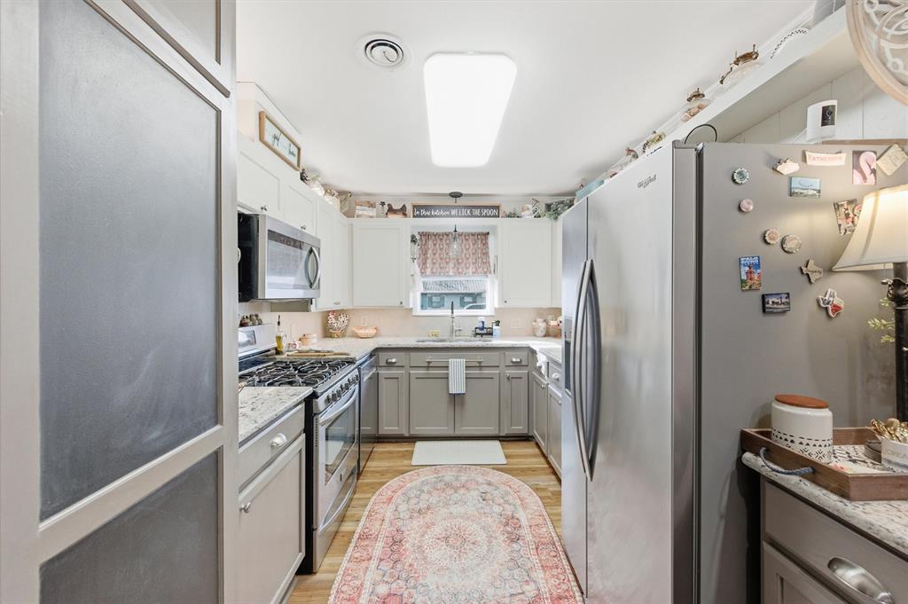 515 Pecan Street Collinsville, TX 76233 - Photo 10 of 39 a kitchen with stainless steel appliances granite countertop a refrigerator stove and sink