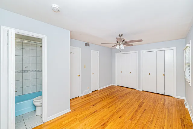 a bedroom with a bed and a toilet