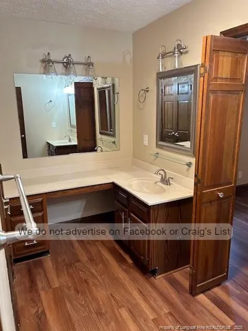 a view of living room with furniture and wooden floor