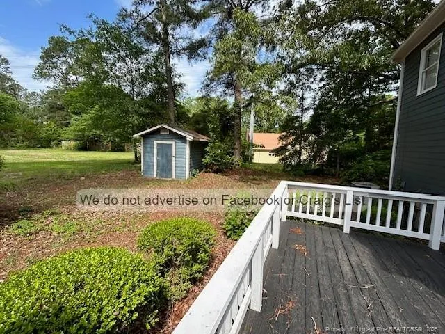a view of house with backyard and trees