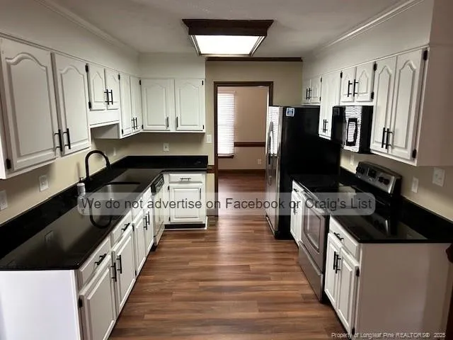 a kitchen with granite countertop a refrigerator and a stove