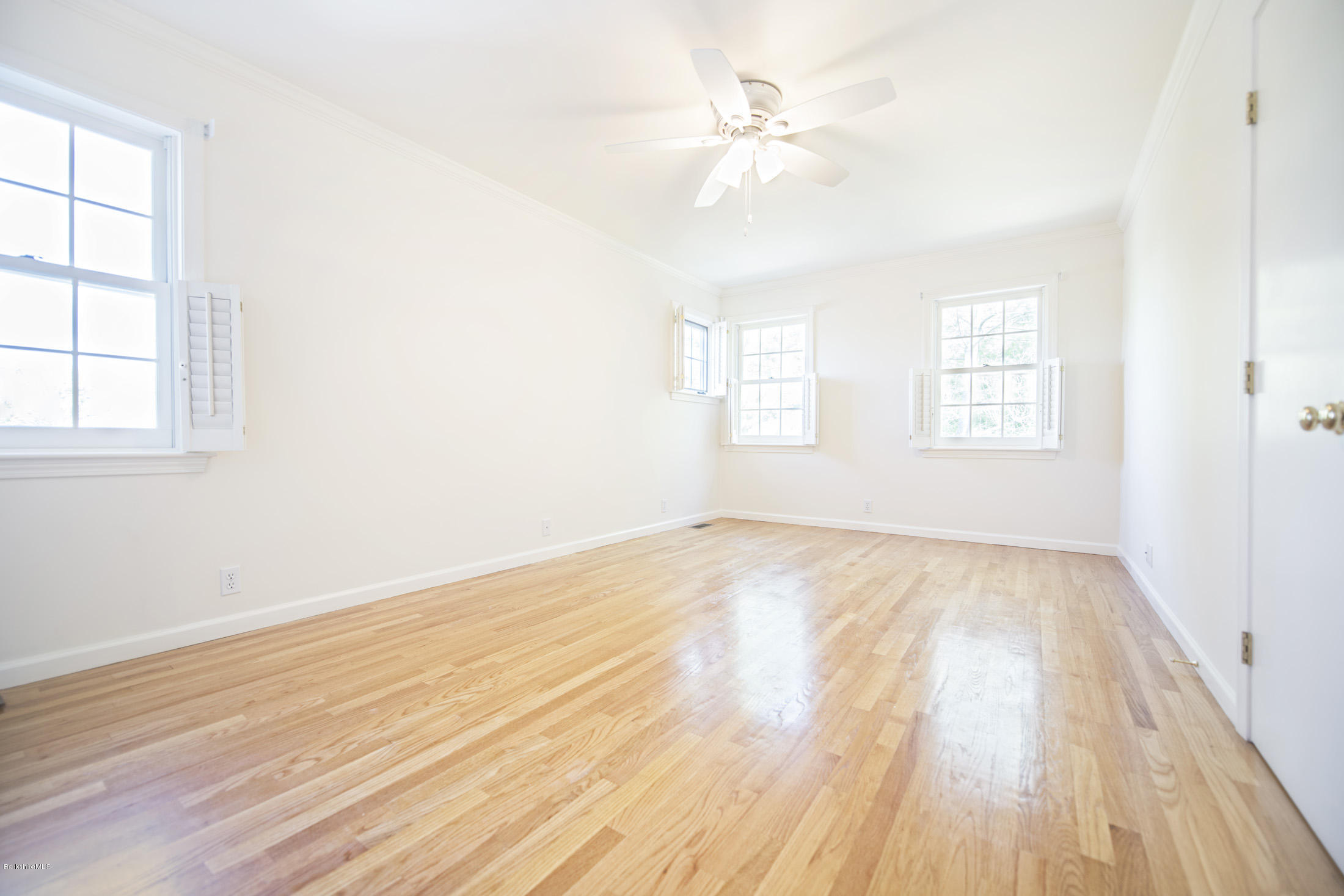 1136 Barker Road, Unit 36 Pittsfield, MA 01201 - Photo 15 of 28 an empty room with wooden floor and windows