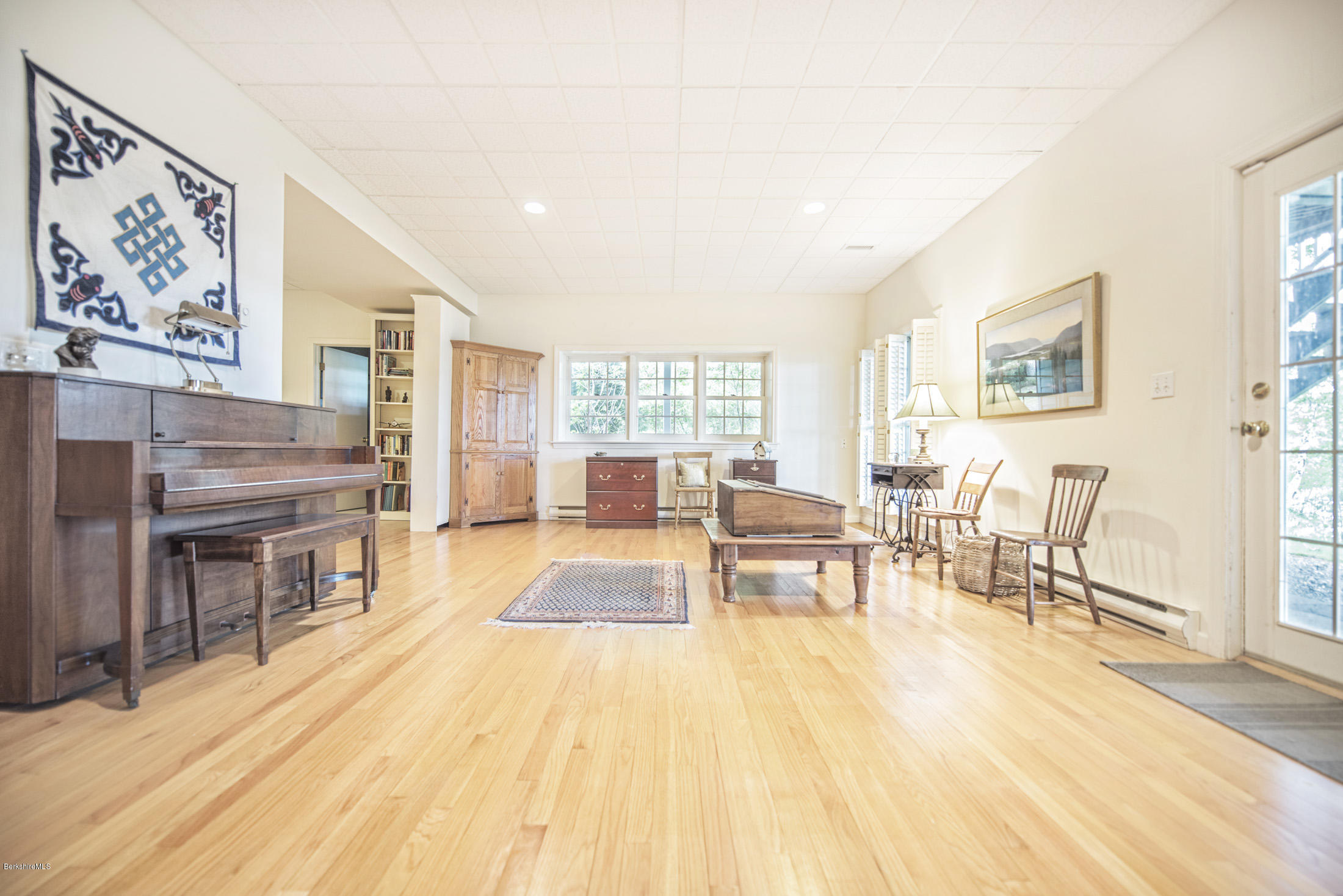 1136 Barker Road, Unit 36 Pittsfield, MA 01201 - Photo 17 of 28 a living room with fireplace furniture and a wooden floor