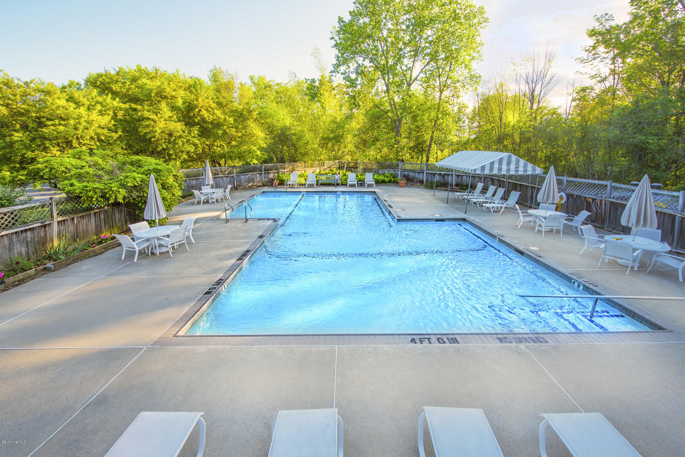 1136 Barker Road, Unit 36 Pittsfield, MA 01201 - Photo 24 of 28 a view of a swimming pool with an outdoor seating