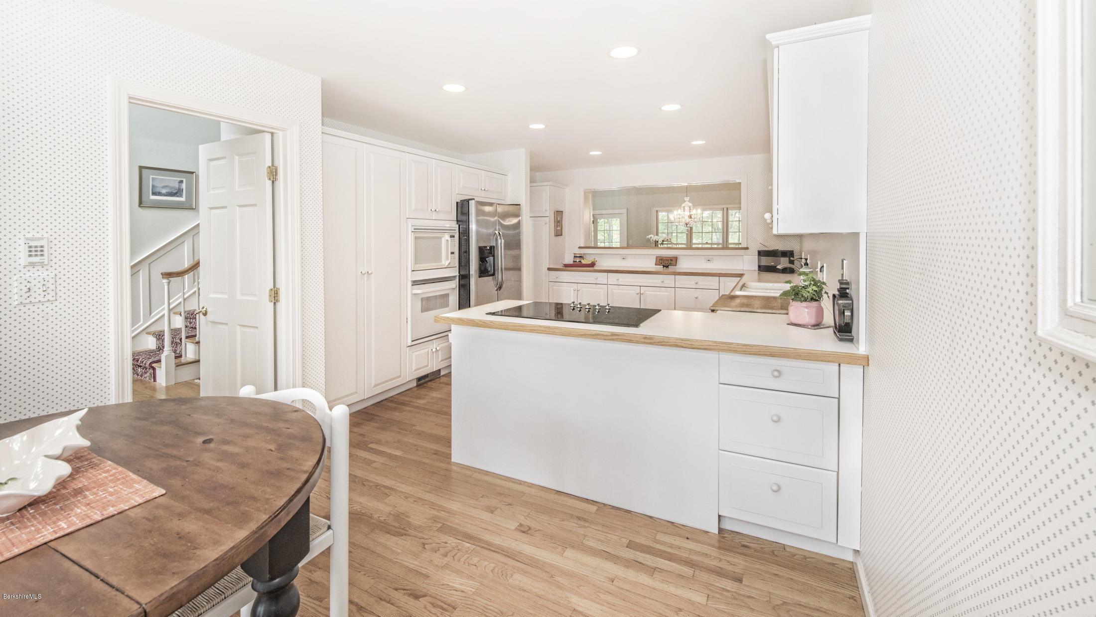 1136 Barker Road, Unit 36 Pittsfield, MA 01201 - Photo 7 of 28 a kitchen with kitchen island a sink appliances and cabinets
