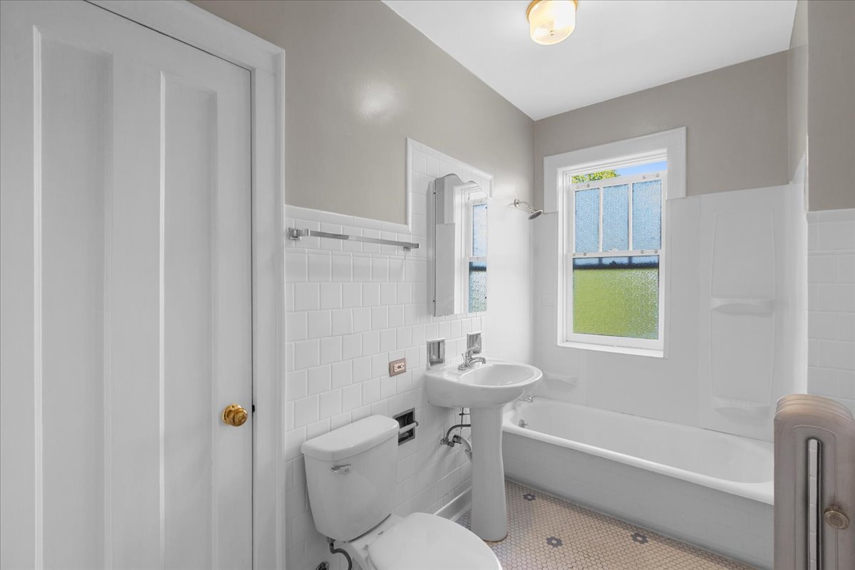 120 Custer Avenue, Unit 3 Evanston, IL 60202 - Photo 11 of 15 a bathroom with a sink a toilet and shower