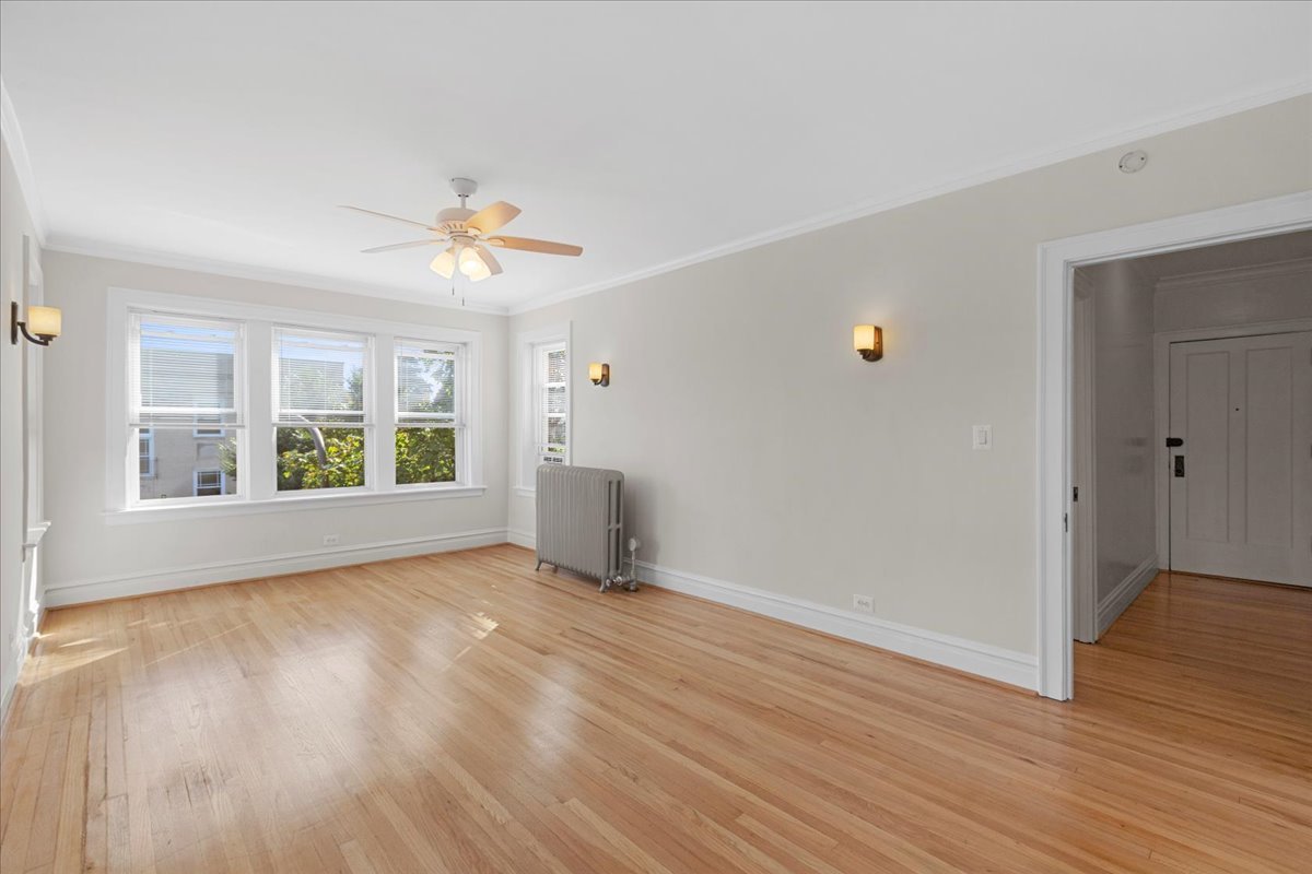 120 Custer Avenue, Unit 3 Evanston, IL 60202 - Photo 4 of 15 a view of an empty room with wooden floor and a window