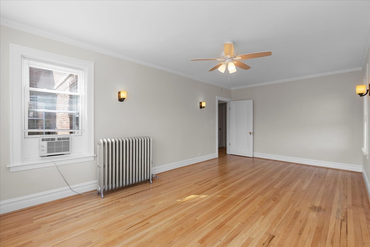 120 Custer Avenue, Unit 3 Evanston, IL 60202 - Photo 5 of 15 a view of empty room with wooden floor and fan