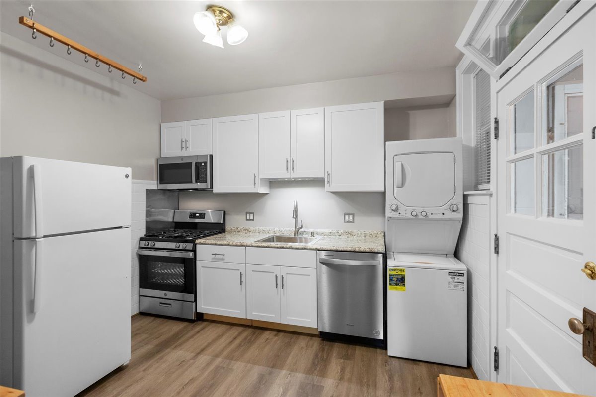 120 Custer Avenue, Unit 3 Evanston, IL 60202 - Photo 6 of 15 a kitchen with cabinets stainless steel appliances and wooden floor