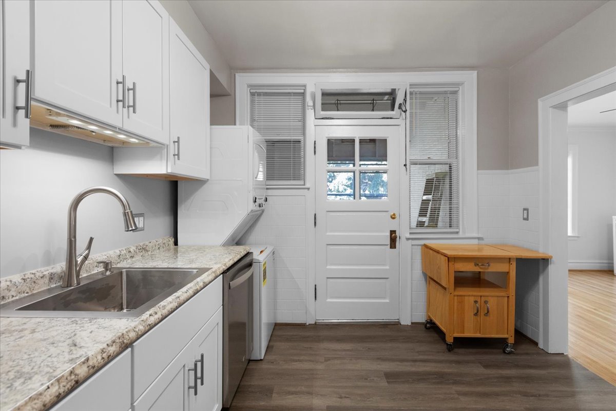 120 Custer Avenue, Unit 3 Evanston, IL 60202 - Photo 7 of 15 a kitchen with stainless steel appliances granite countertop a sink and dishwasher stove with wooden cabinets