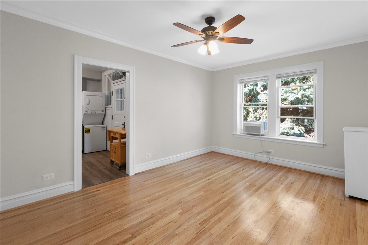 120 Custer Avenue, Unit 3 Evanston, IL 60202 - Photo 9 of 15 wooden floor in an empty room with a window