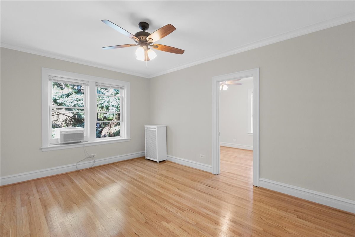 120 Custer Avenue, Unit 3 Evanston, IL 60202 - Photo 10 of 15 wooden floor in an empty room with a window