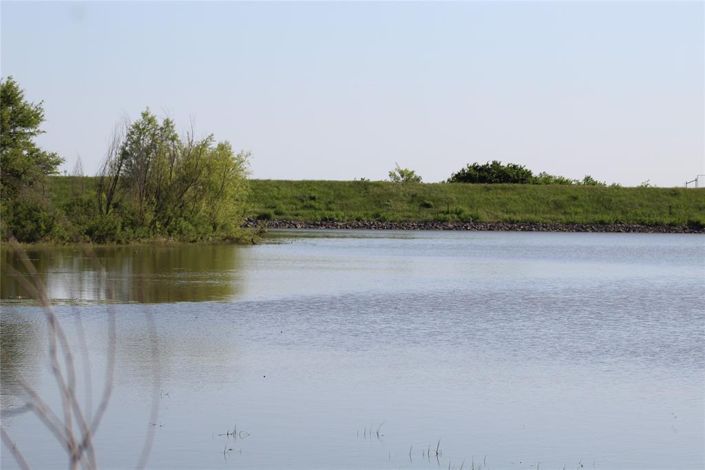 2077 A Shawver Road Perrin, TX 76486 - Photo 30 of 35 Body of water surrounded by lush greenery and a grassy embankment