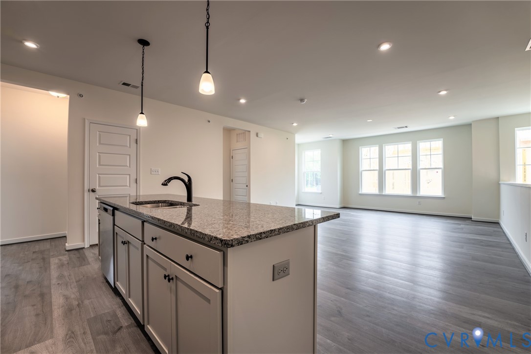 4003 Next Level Trace Midlothian, VA 23112 - Photo 9 of 38 a kitchen with stainless steel appliances granite countertop a sink a stove a window and wooden floor