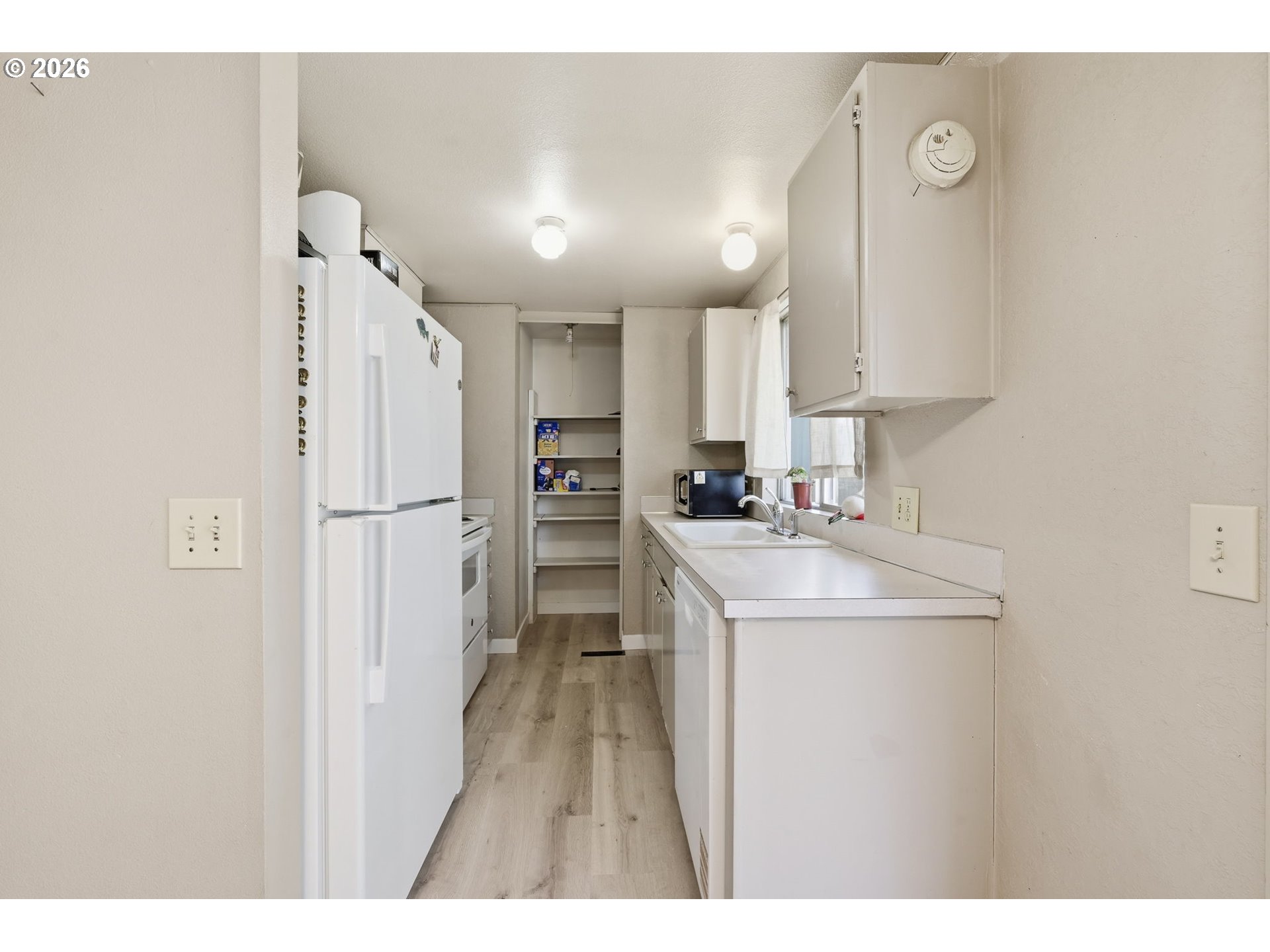 87988 6th Street Veneta, OR 97487 - Photo 12 of 20 a kitchen with refrigerator cabinets and a sink