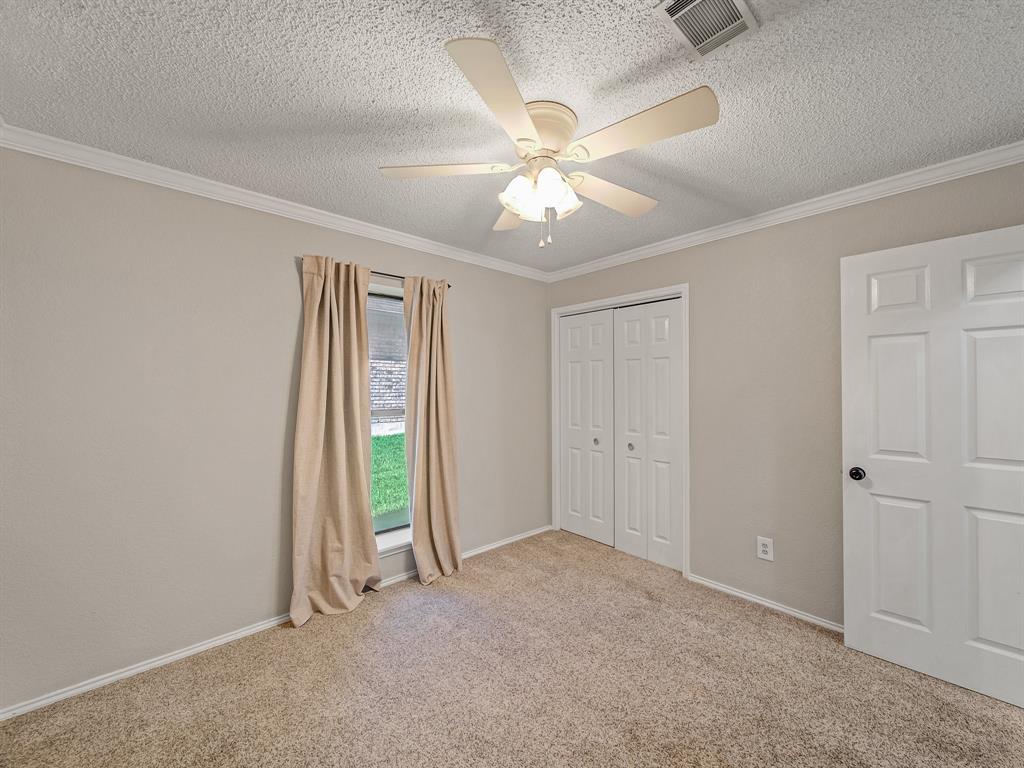 121 Northeast Brushy Mound Road Burleson, TX 76028 - Photo 24 of 35 an empty room with closet and a chandelier fan