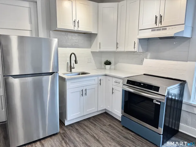 a kitchen with cabinets and steel stainless steel appliances