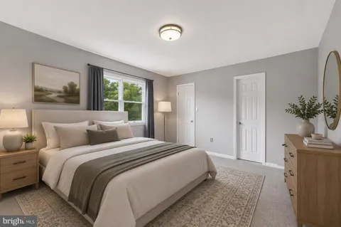 a bedroom with a bed and a potted plant