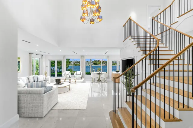 a large white kitchen with a large window and swimming pool