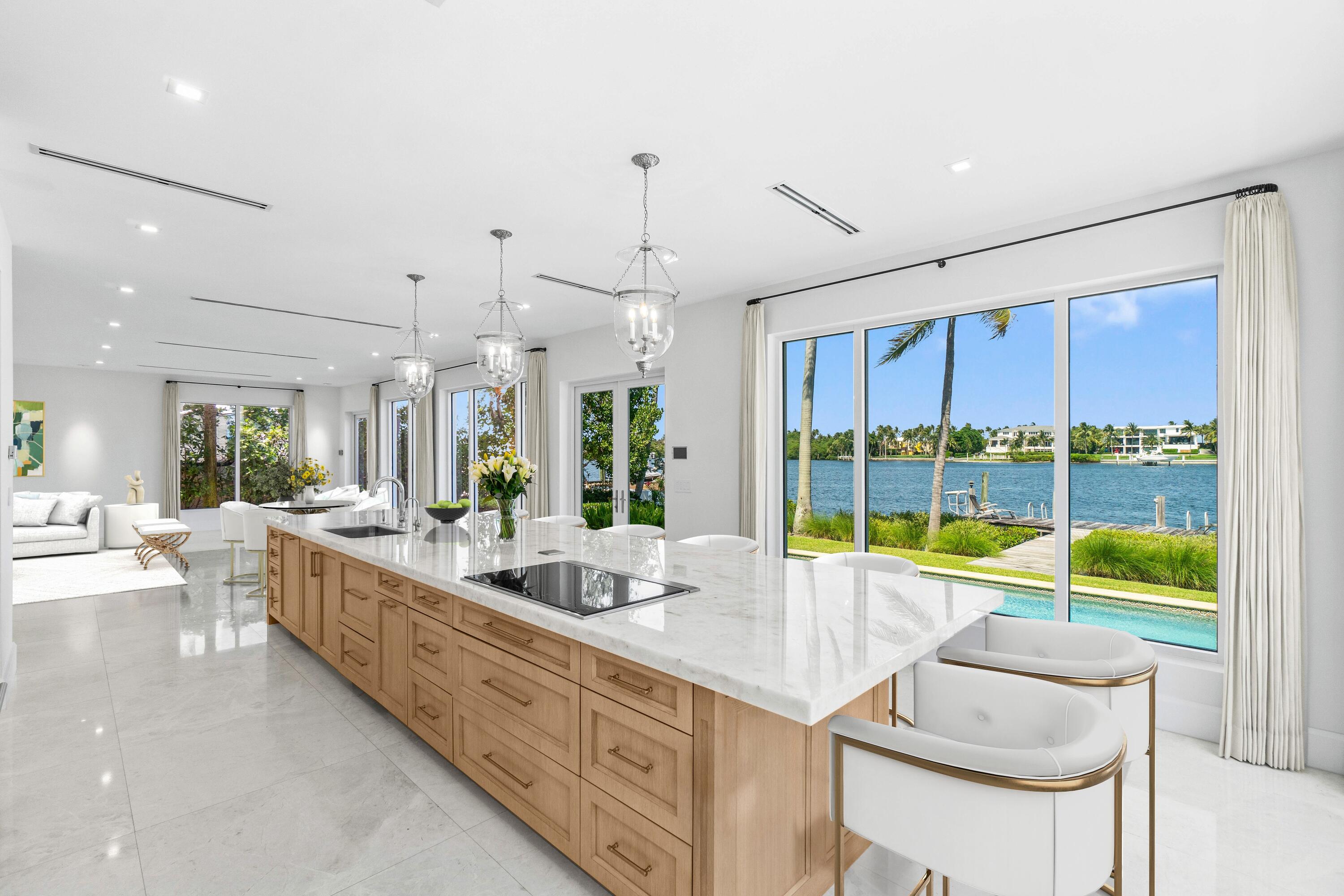 1690 Lands End Road Manalapan, FL 33462 - Photo 19 of 59 a large kitchen with kitchen island a large window cabinets and furniture