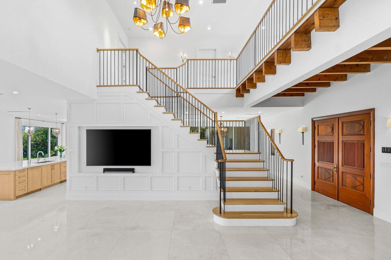 1690 Lands End Road Manalapan, FL 33462 - Photo 23 of 59 a room with stairs and a fireplace