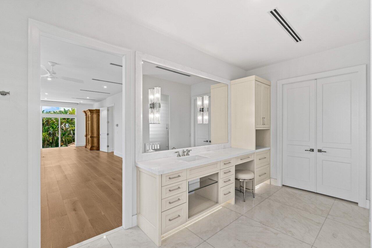 1690 Lands End Road Manalapan, FL 33462 - Photo 29 of 59 a bathroom with a granite countertop sink mirror and