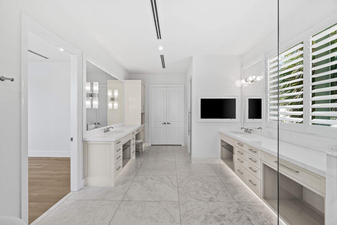 1690 Lands End Road Manalapan, FL 33462 - Photo 31 of 59 a large bathroom with a double vanity sink a mirror and shower