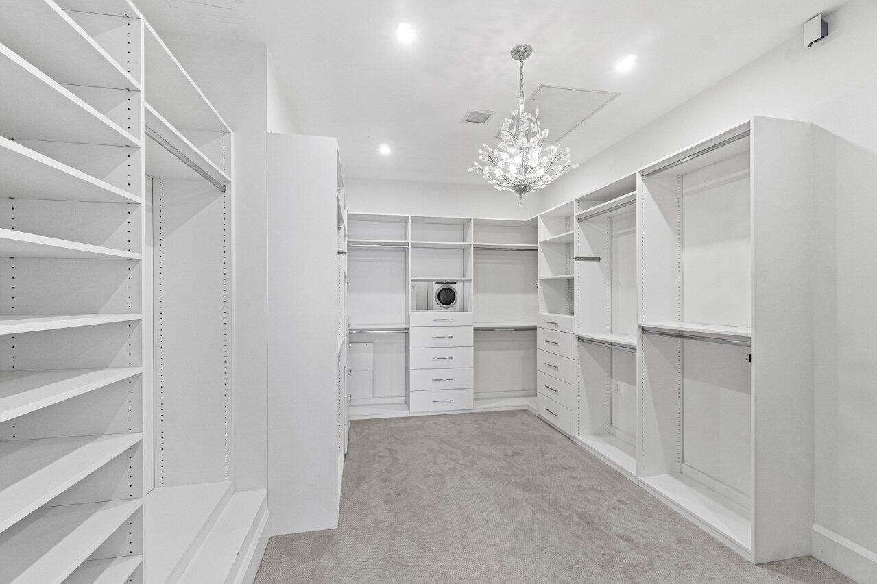1690 Lands End Road Manalapan, FL 33462 - Photo 35 of 59 a view of a kitchen with white cabinets and chandelier
