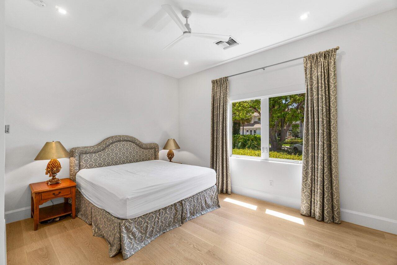 1690 Lands End Road Manalapan, FL 33462 - Photo 43 of 59 a bedroom with a bed and wooden floor