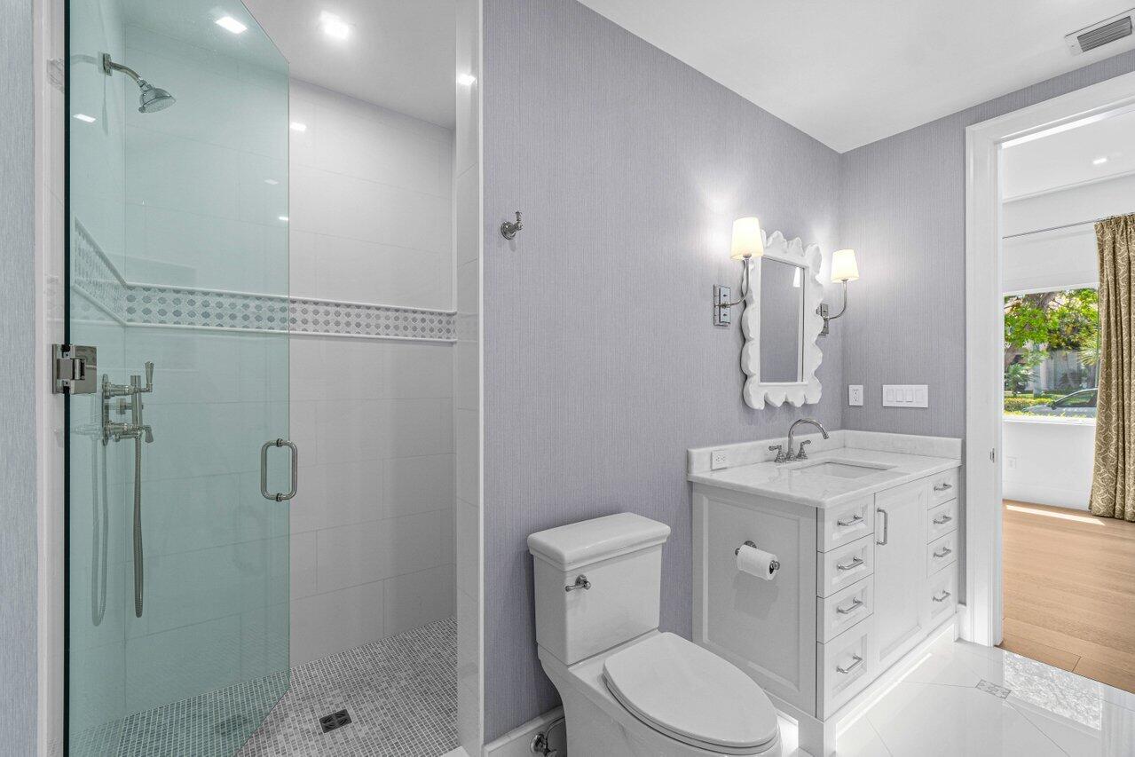 1690 Lands End Road Manalapan, FL 33462 - Photo 44 of 59 a bathroom with a toilet sink shower and mirror