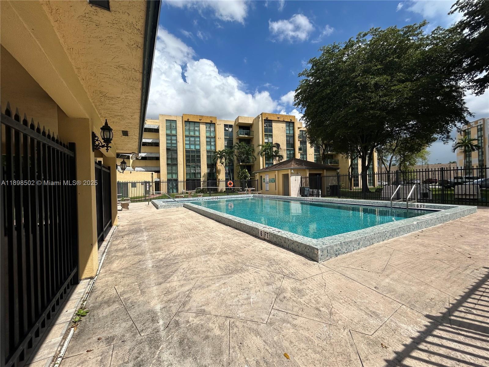 11780 Southwest 18th Street, Unit 4182 Miami, FL 33175 - Photo 14 of 14 a view of a swimming pool with a yard