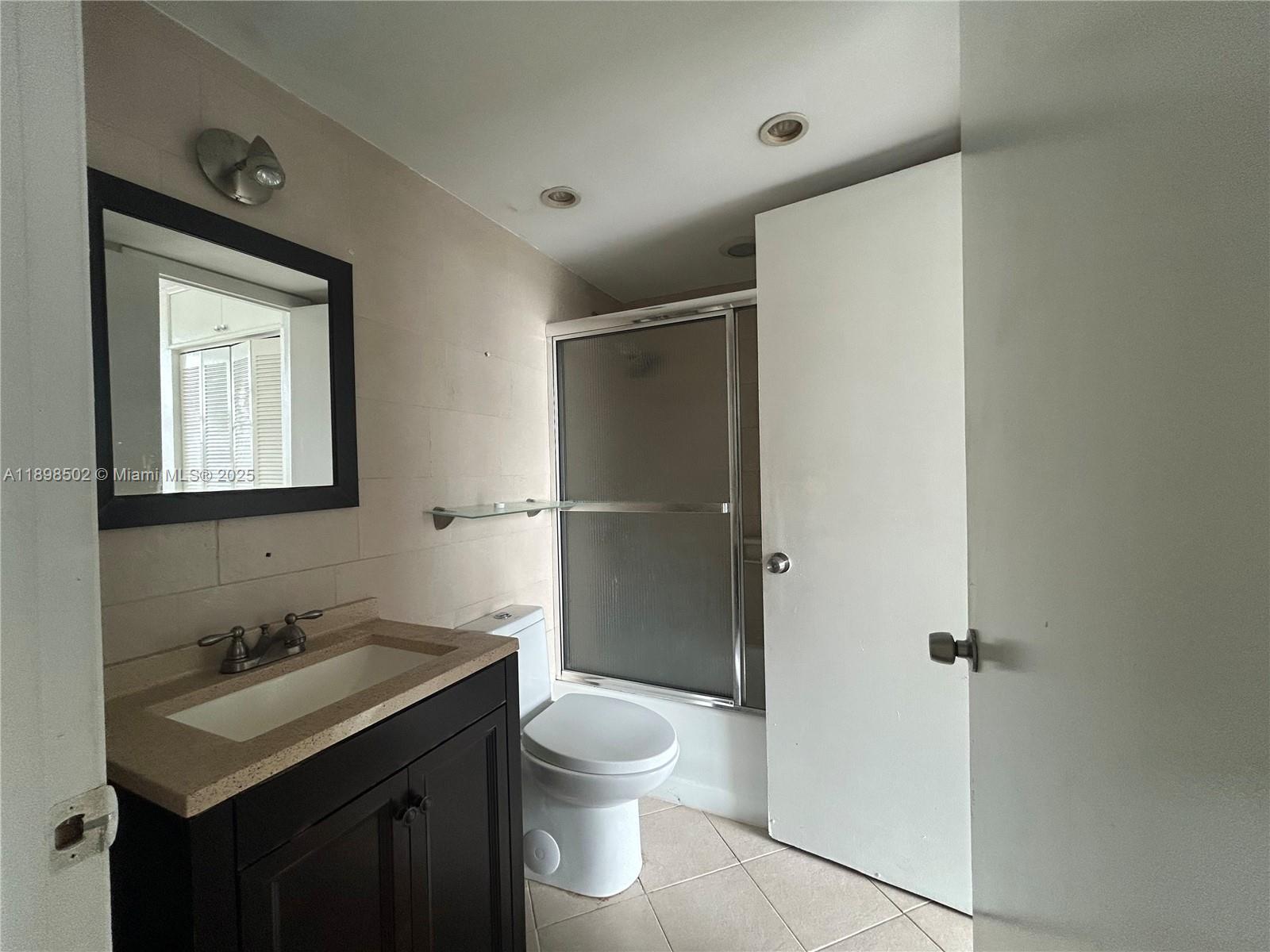 11780 Southwest 18th Street, Unit 4182 Miami, FL 33175 - Photo 3 of 14 a bathroom with a sink toilet and shower