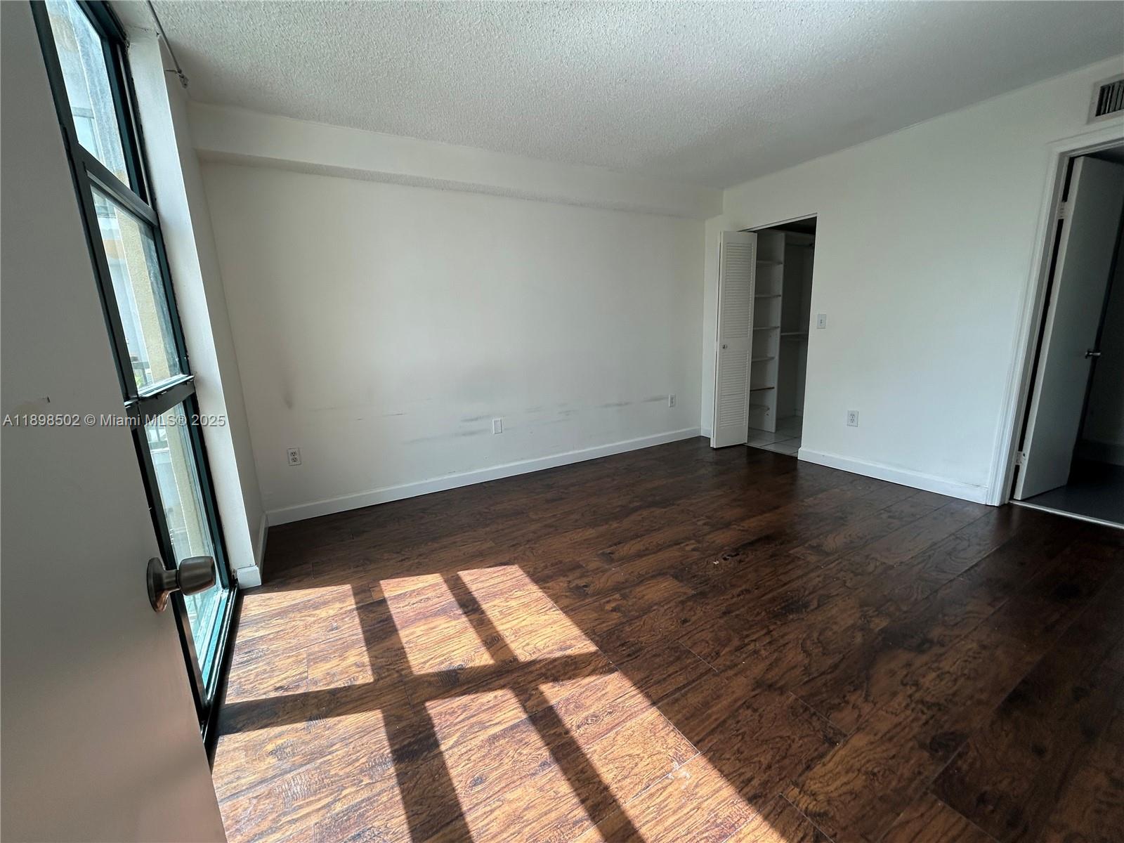 11780 Southwest 18th Street, Unit 4182 Miami, FL 33175 - Photo 5 of 14 a view of an empty room and wooden floor