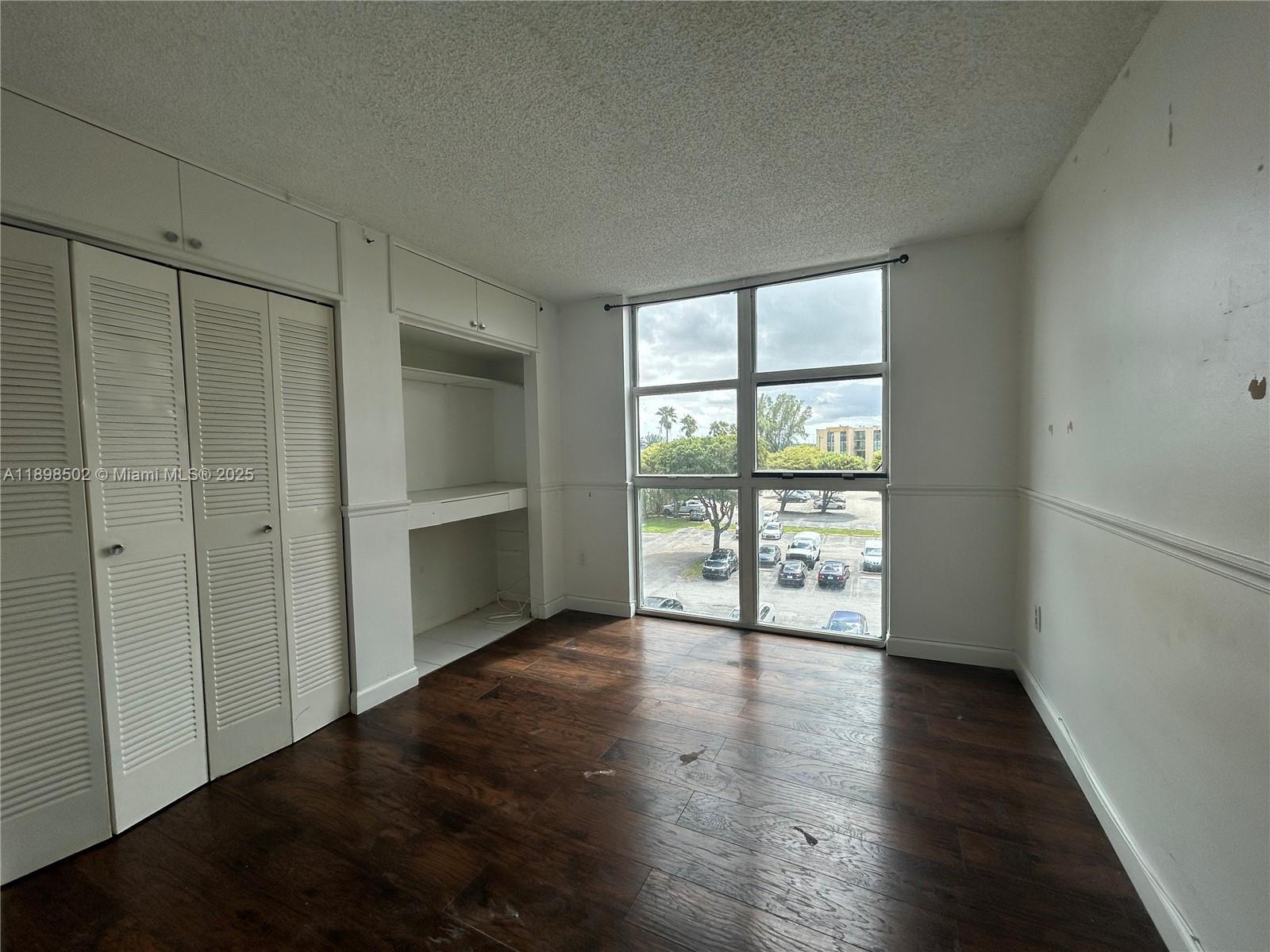 11780 Southwest 18th Street, Unit 4182 Miami, FL 33175 - Photo 6 of 14 wooden floor in an empty room with a window
