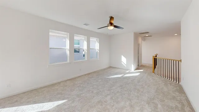 a view of a livingroom with a ceiling fan and window