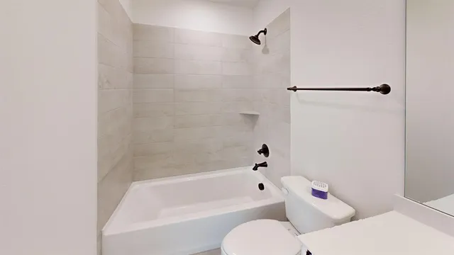a bathroom with a bathtub and a toilet