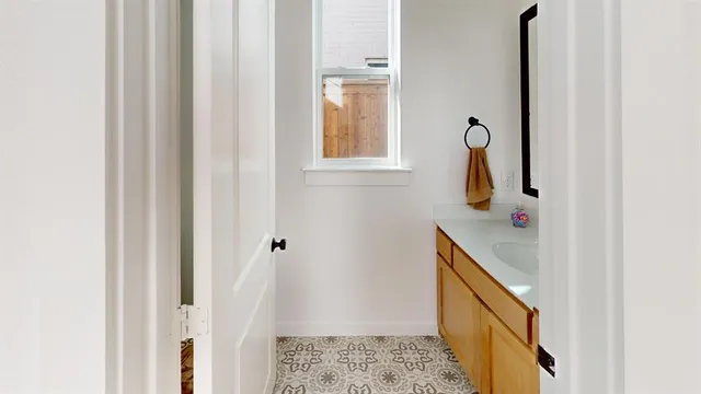a bathroom with a sink and mirror